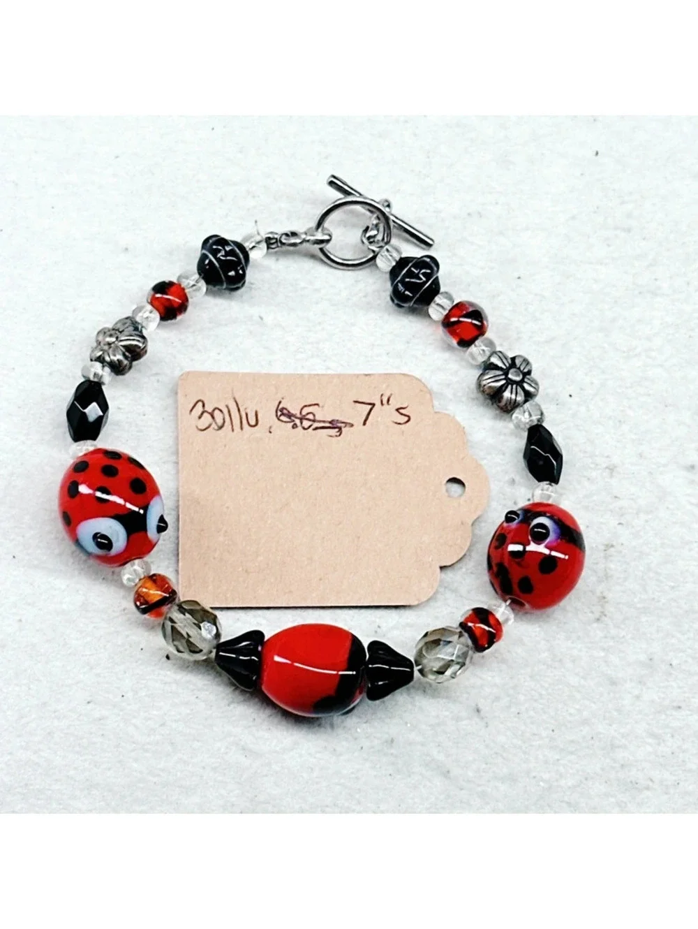 3011u. Silly Ladybug Glass Bracelet Silvertone
